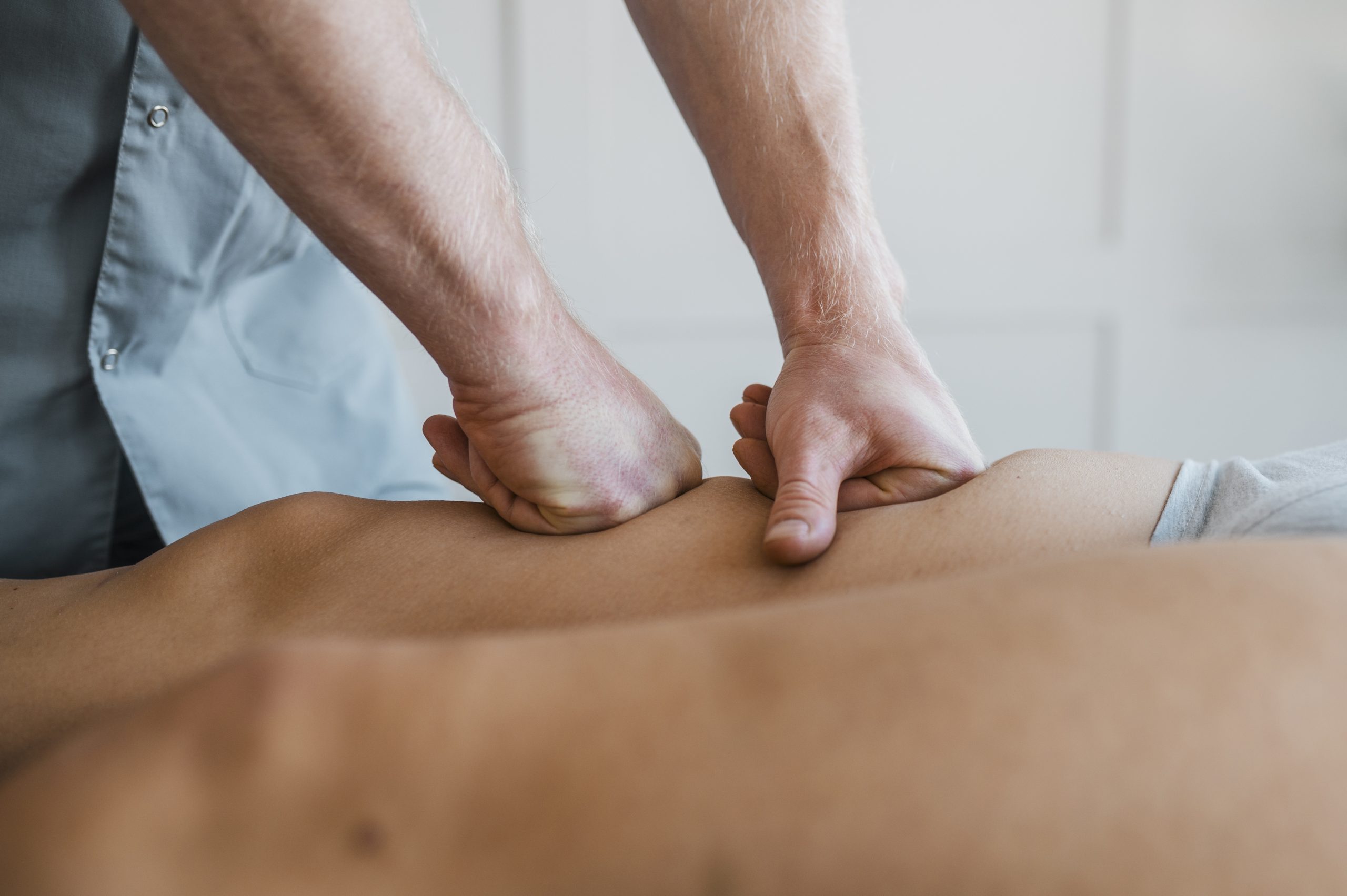 male-physiotherapist-massage-session-with-female-patient