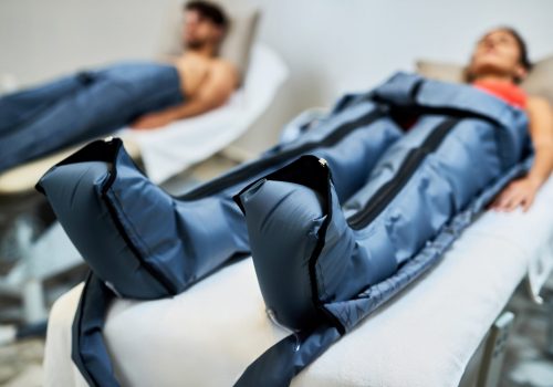 Close-up of a couple having pressotherapy at health spa.