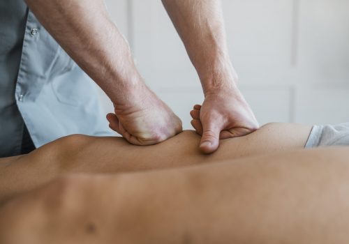 male-physiotherapist-massage-session-with-female-patient
